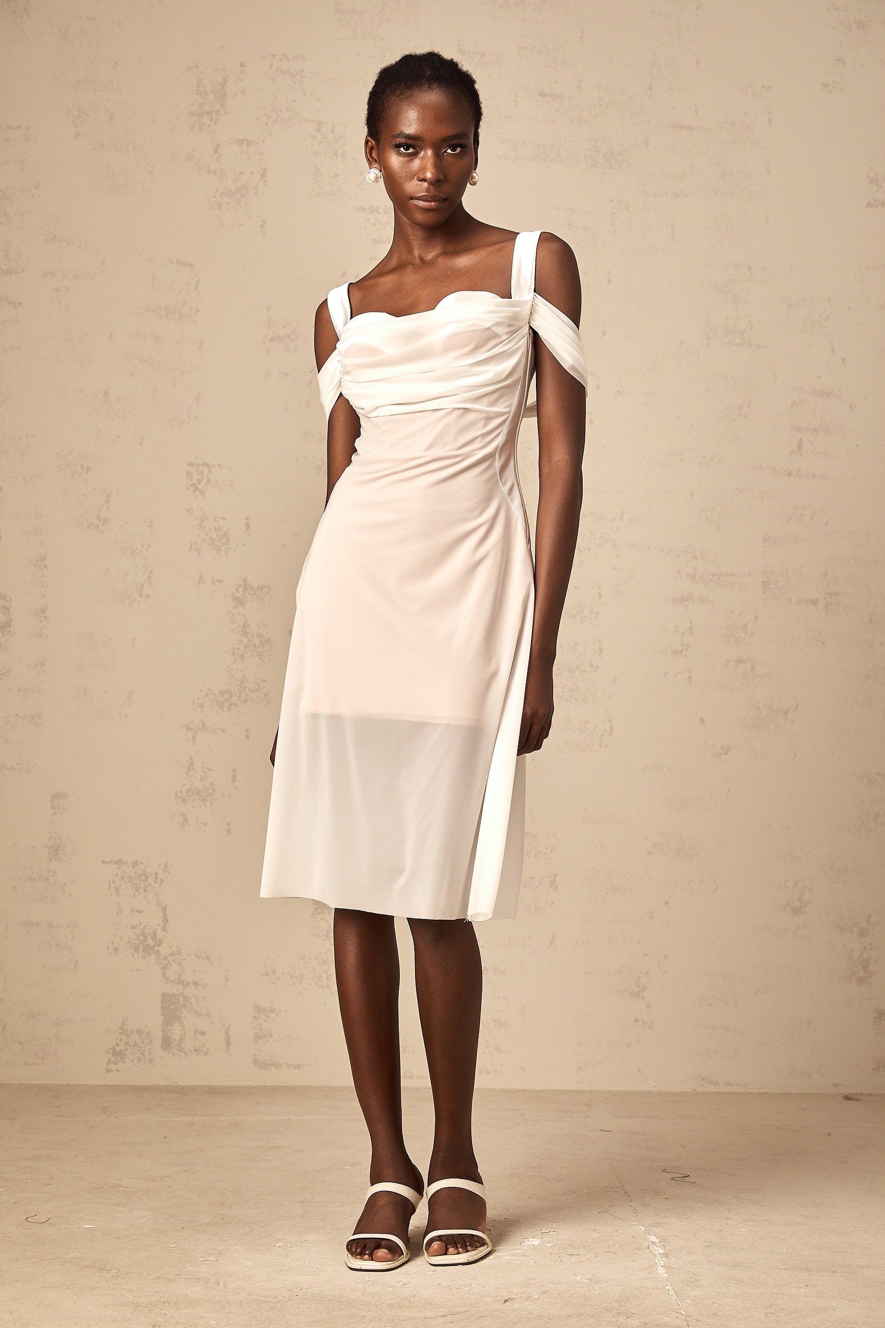 A white semi sheer midi dress with ruched detailing named Gloria