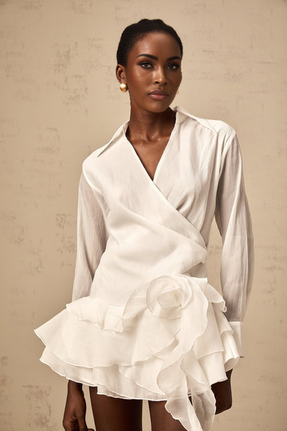 A white semi sheer mini dress with floral pattern and ruffled details named Solene