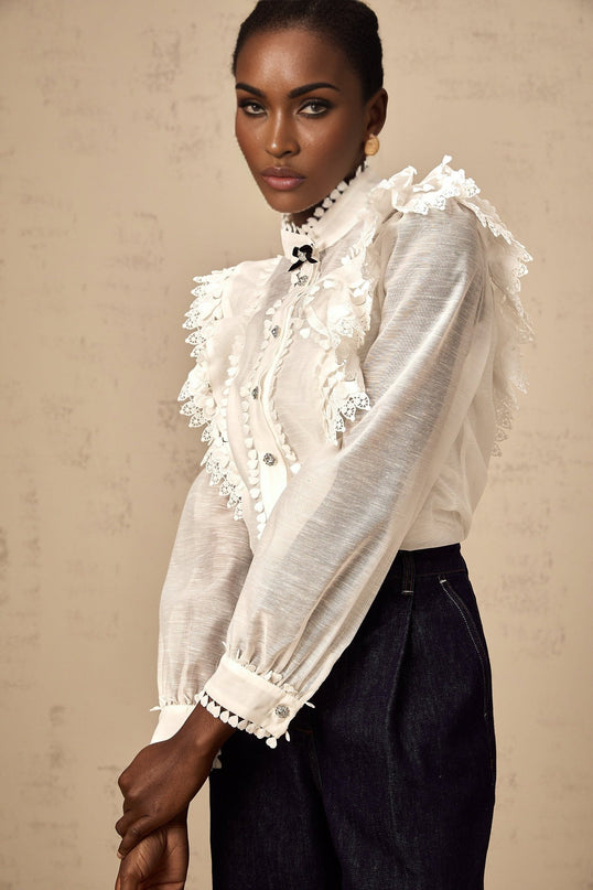 A white semi sheer shirt with delicate lace trim details named Capucine