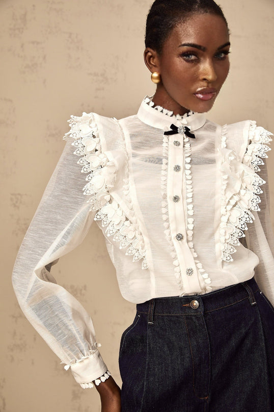 A white semi sheer shirt with lace trim details named Capucine