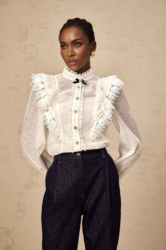 A white semi sheer shirt with lace trim details named Capucine