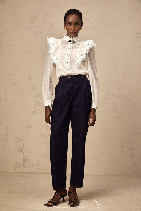 A white semi sheer shirt with lace trim details named Capucine