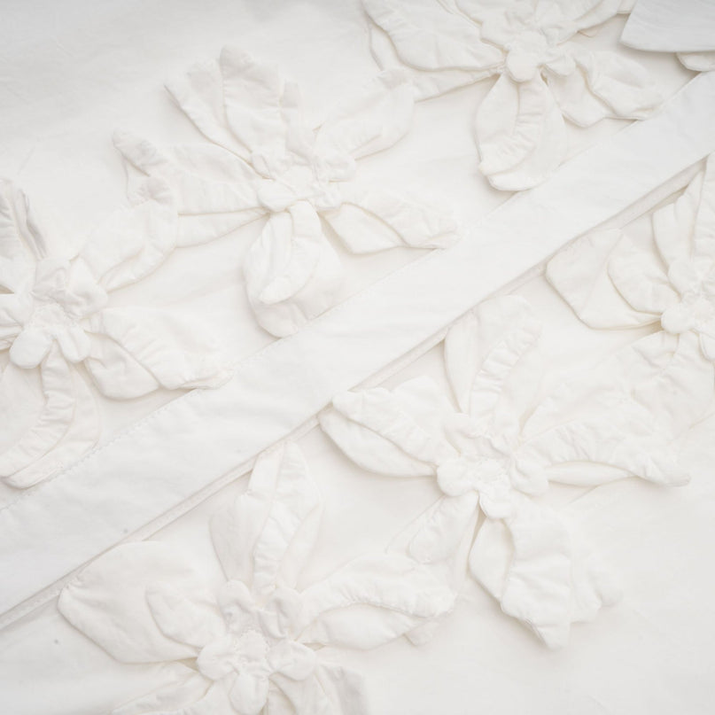 A white shirt with floral pattern featuring cut out details on a woman named Rosalie