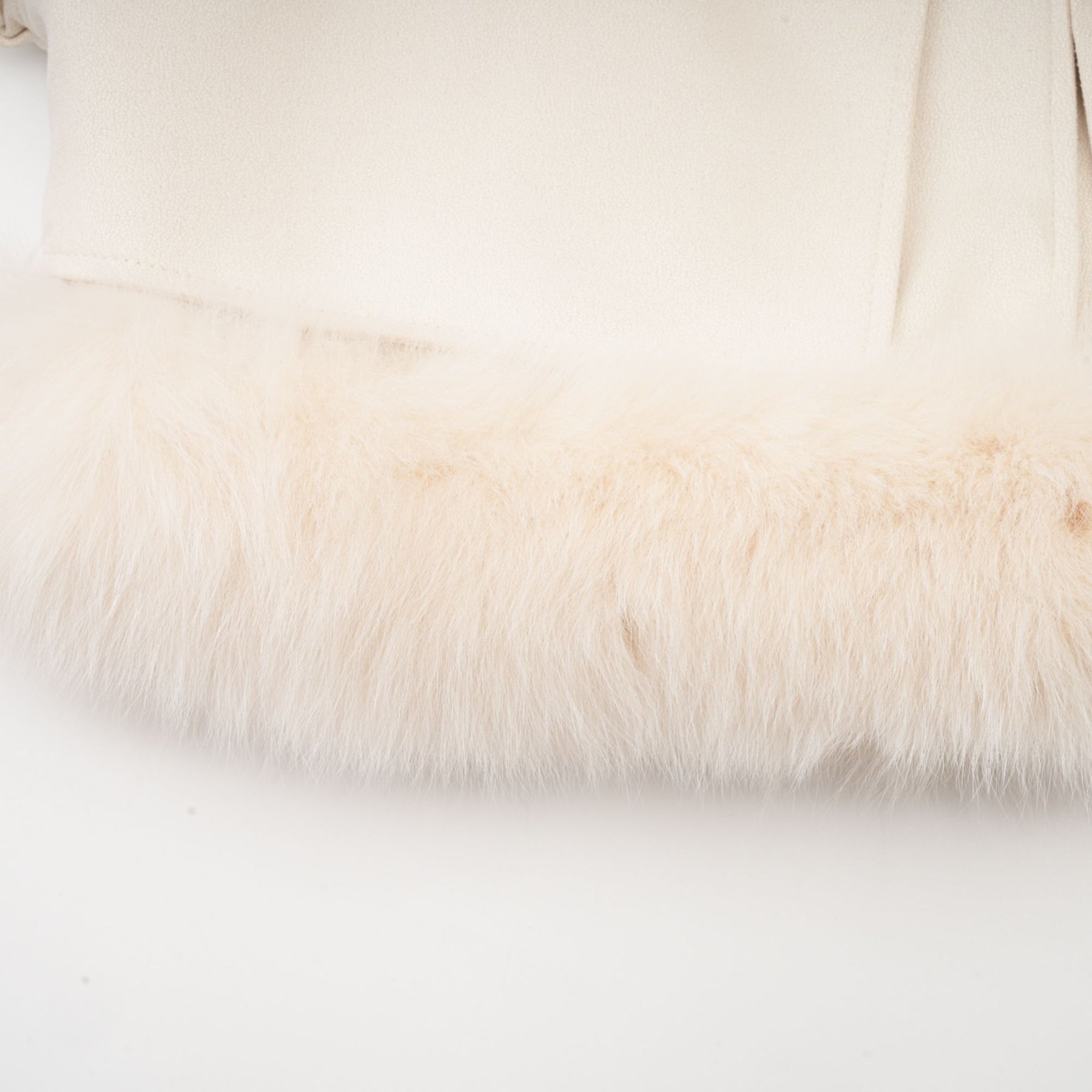 A white short coat made of suede with fur padding and a padded design