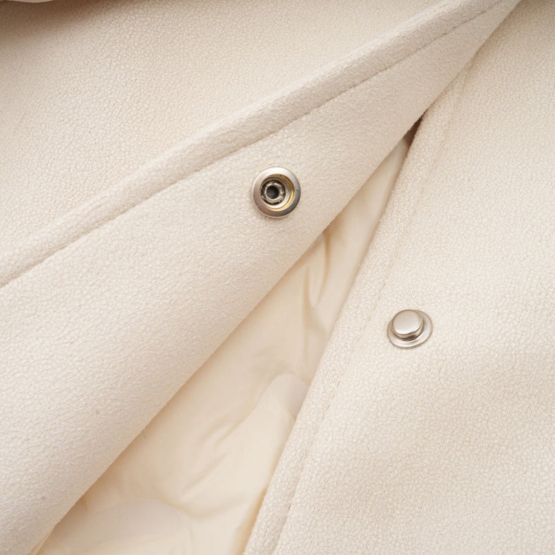 A white short coat made of suede with fur padding and lining featuring a cozy winter design