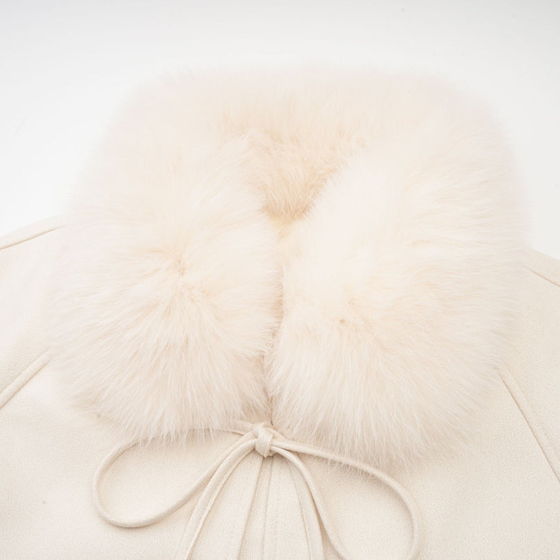 A white short coat made of suede with fur padding and lining featuring a cozy winter design