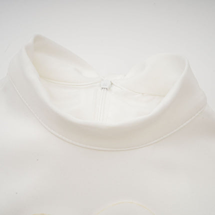 A white sleeveless maxi dress with a bow and artificial flower embellishment named Magali