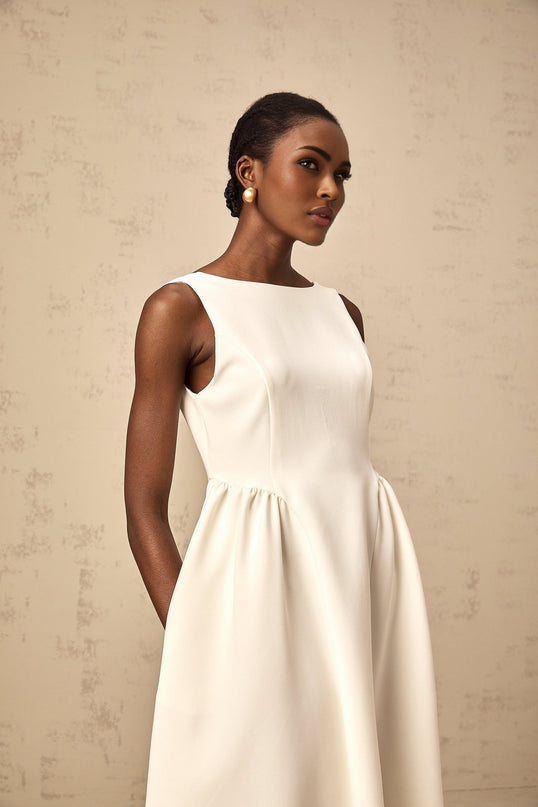 A white sleeveless midi dress with a full skirt named Yolanda