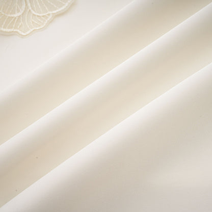 A white sleeveless midi dress with floral applique details named Emilie