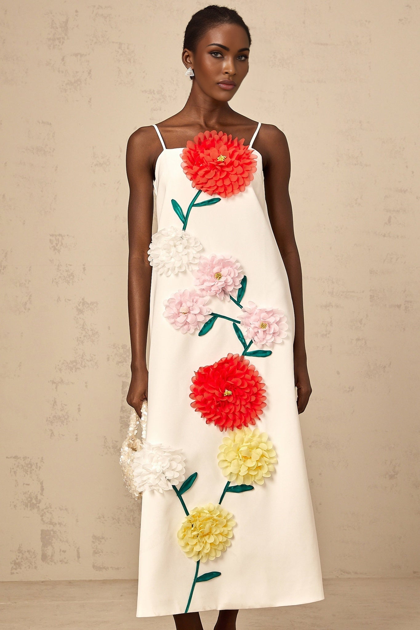 A white sleeveless midi dress with three dimensional floral petal details