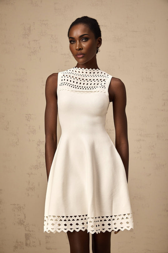 A white sleeveless mini dress with cutout details featuring a knitted fabric and a formfitting silhouette named Colette