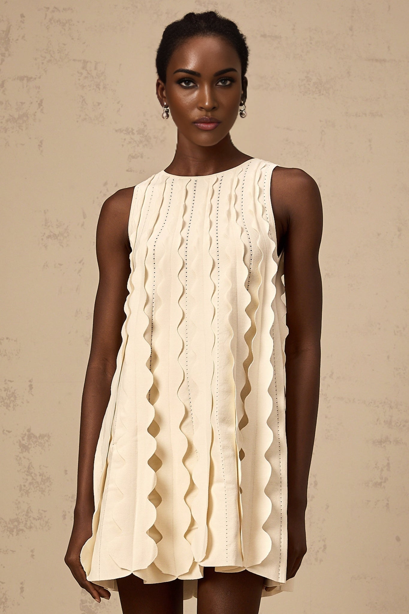 A white sleeveless mini dress with wavy details named Axelle
