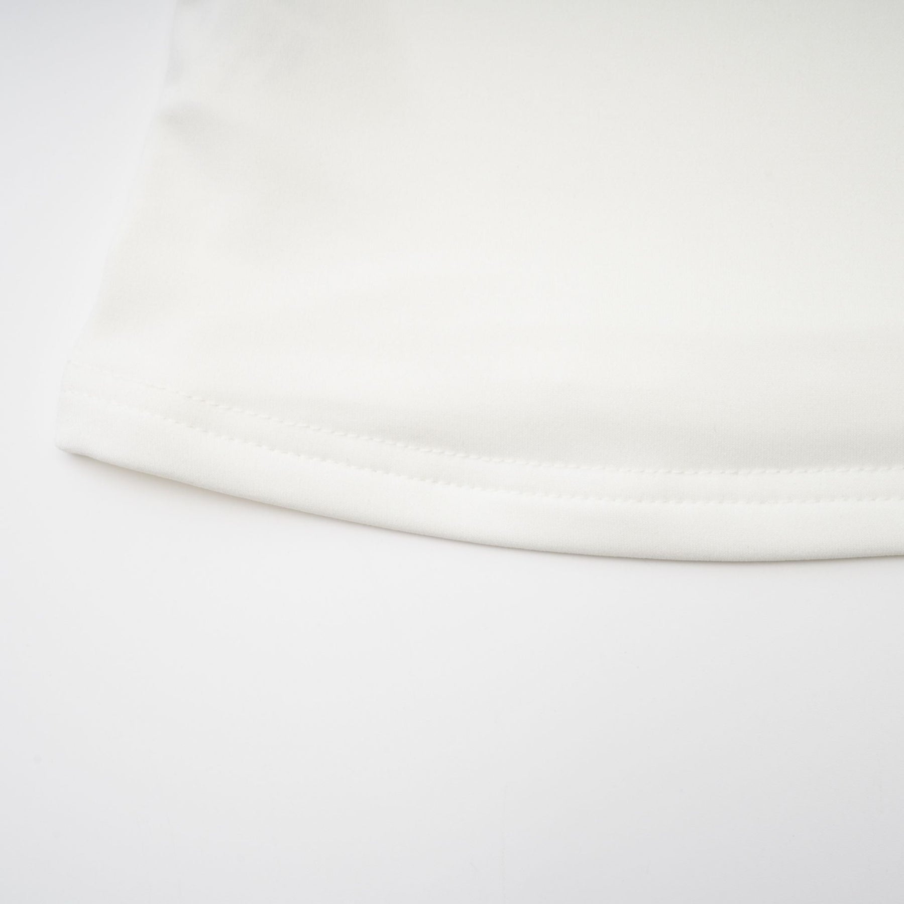 A white sleeveless top with gathered details featuring a relaxed fit and feminine design