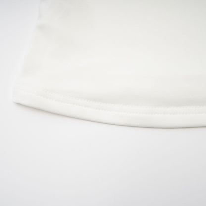 A white sleeveless top with gathered details featuring a relaxed fit and feminine design