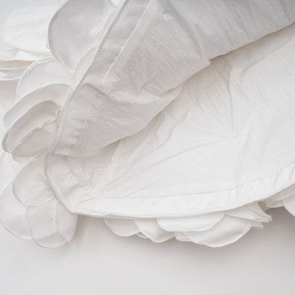 A white strapless mini dress with a corset style bodice decorated with floral petal details named Lucie