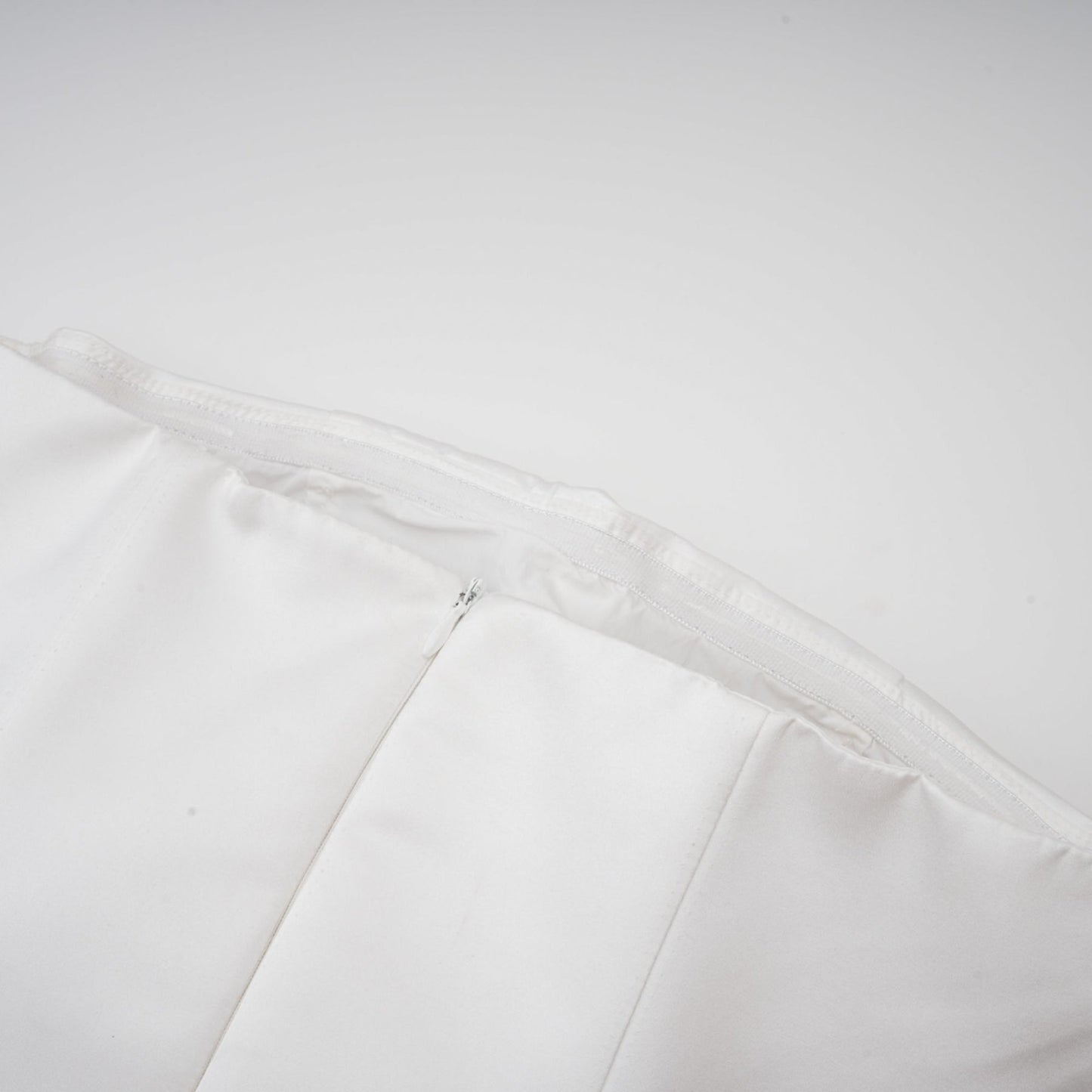 A white strapless mini dress with a corsetstyle bodice adorned with floral petal details named Lucie