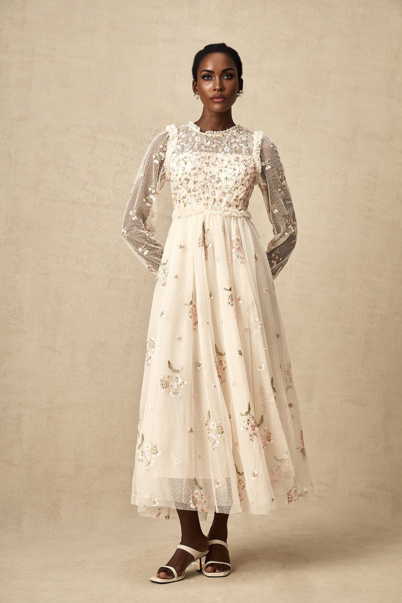 A white tulle midi dress with delicate floral embroidery featuring a fitted bodice and flowing skirt by Celine