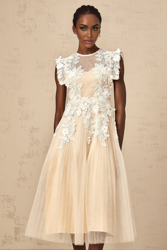 A white tulle midi dress with floral appliques scattered across the bodice and skirt featuring a fitted waist and delicate straps