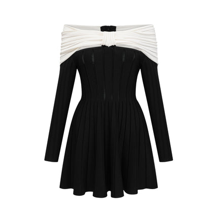 A woman wearing a black offshoulder mini dress with a bow detail and knit fabric