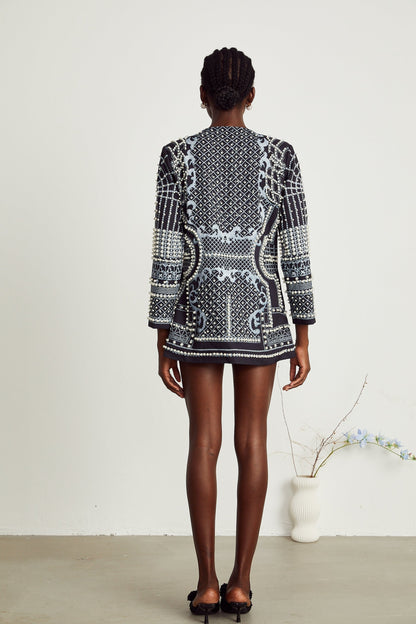 A woman wearing a blazer dress with a Vneck and a Catherine pattern print design