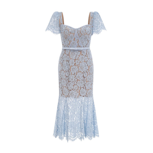A woman wearing a blue midi dress with floral lace pattern and boned bodice