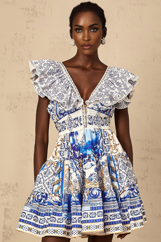 A woman wearing a blue mini dress with a baroque print pattern and tiered layers