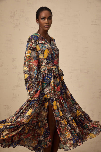 A woman wearing a brown bohemian style midi dress with shirring details and a flowy silhouette