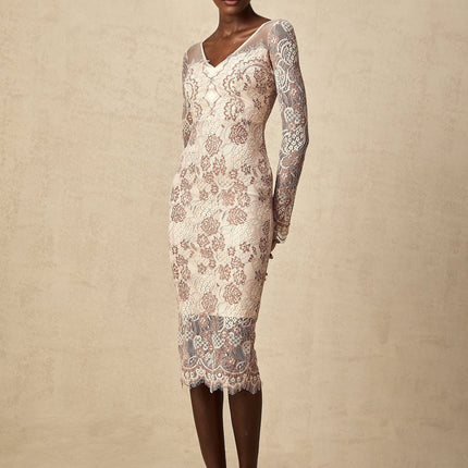 A woman wearing a fitted midi dress made of Anna guipure lace standing in an elegant pose