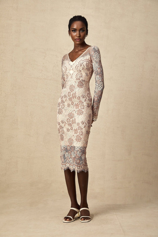 A woman wearing a fitted midi dress made of Anna guipure lace standing in an elegant pose