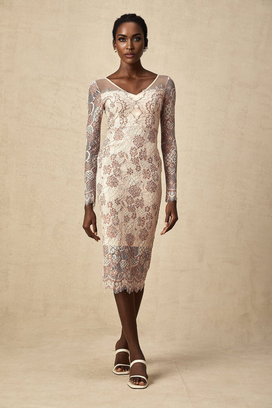 A woman wearing a fitted midi dress made of white guipure lace standing in a neutral background