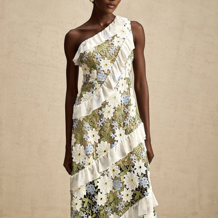 A woman wearing a floral embroidered midi dress with a delicate pattern and soft color palette