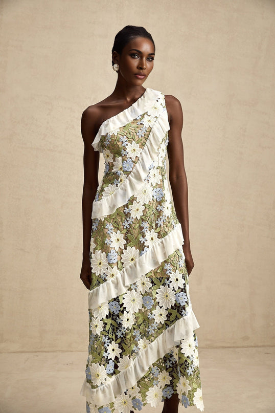 A woman wearing a floral embroidered midi dress with a delicate pattern and soft color palette