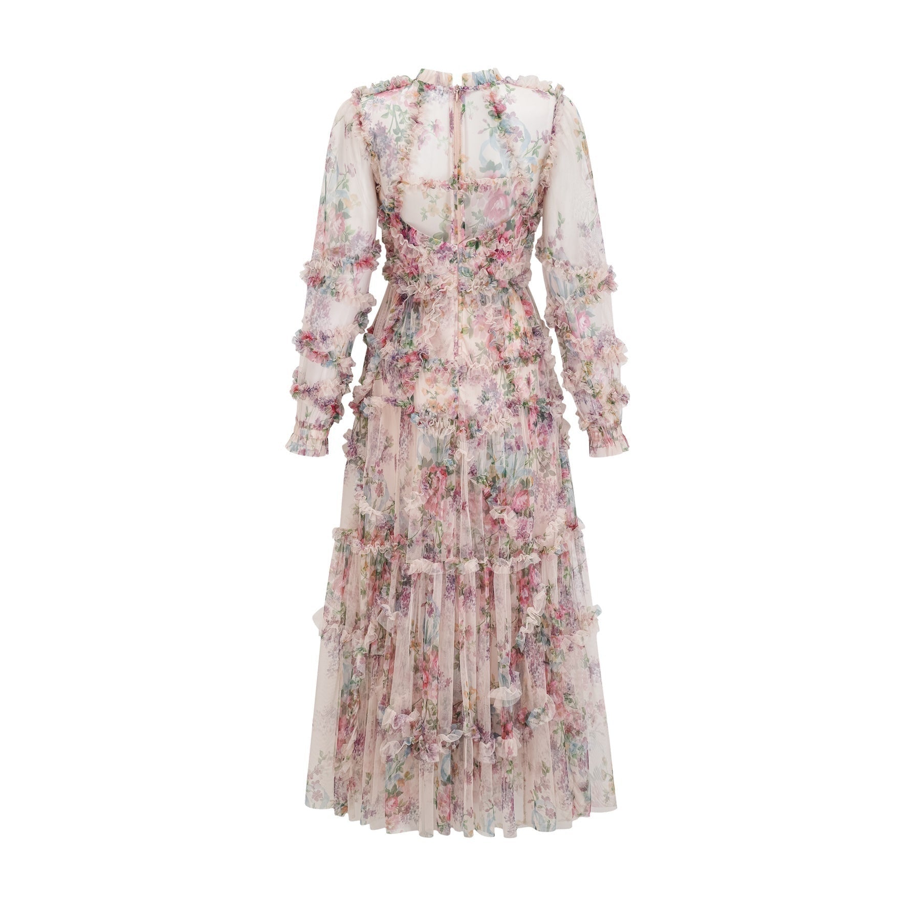 A woman wearing a floral patterned midi dress with ruffled details and a tulle skirt standing in a relaxed pose