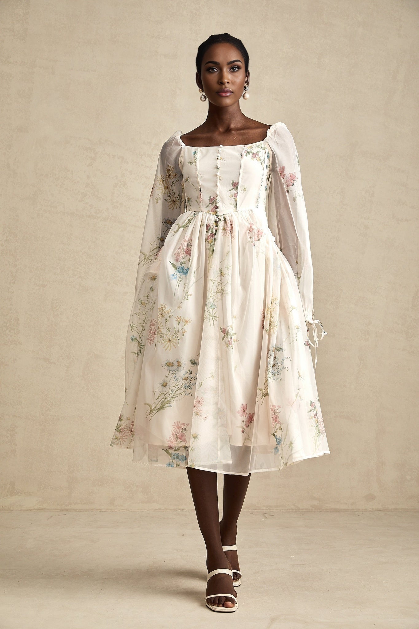 A woman wearing a floral print midi dress with a square neckline named Anne