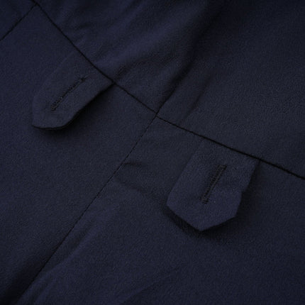 A woman wearing a long blue dress with a fitted waist and flared bottom featuring a peplum detail and panelled design