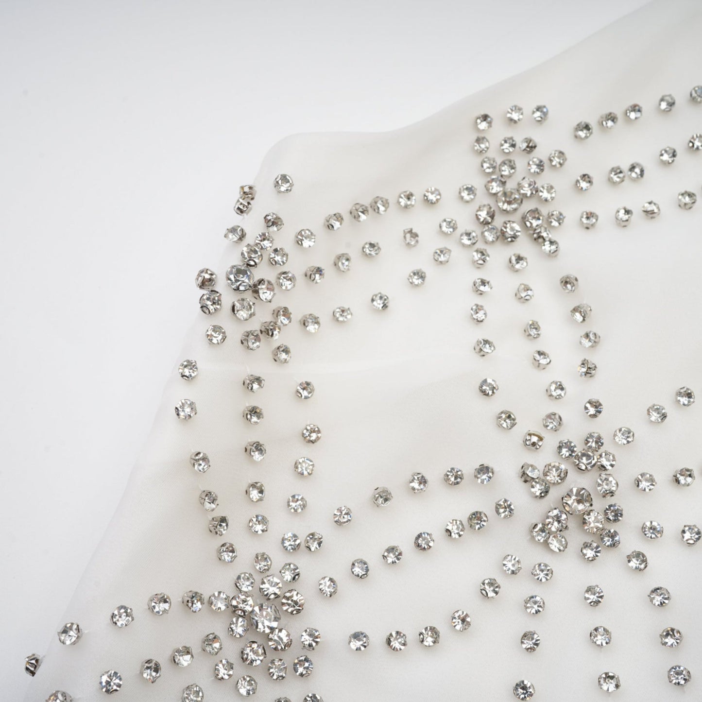 A woman wearing a long formal dress with embellishments and intricate detailing named Magdalena