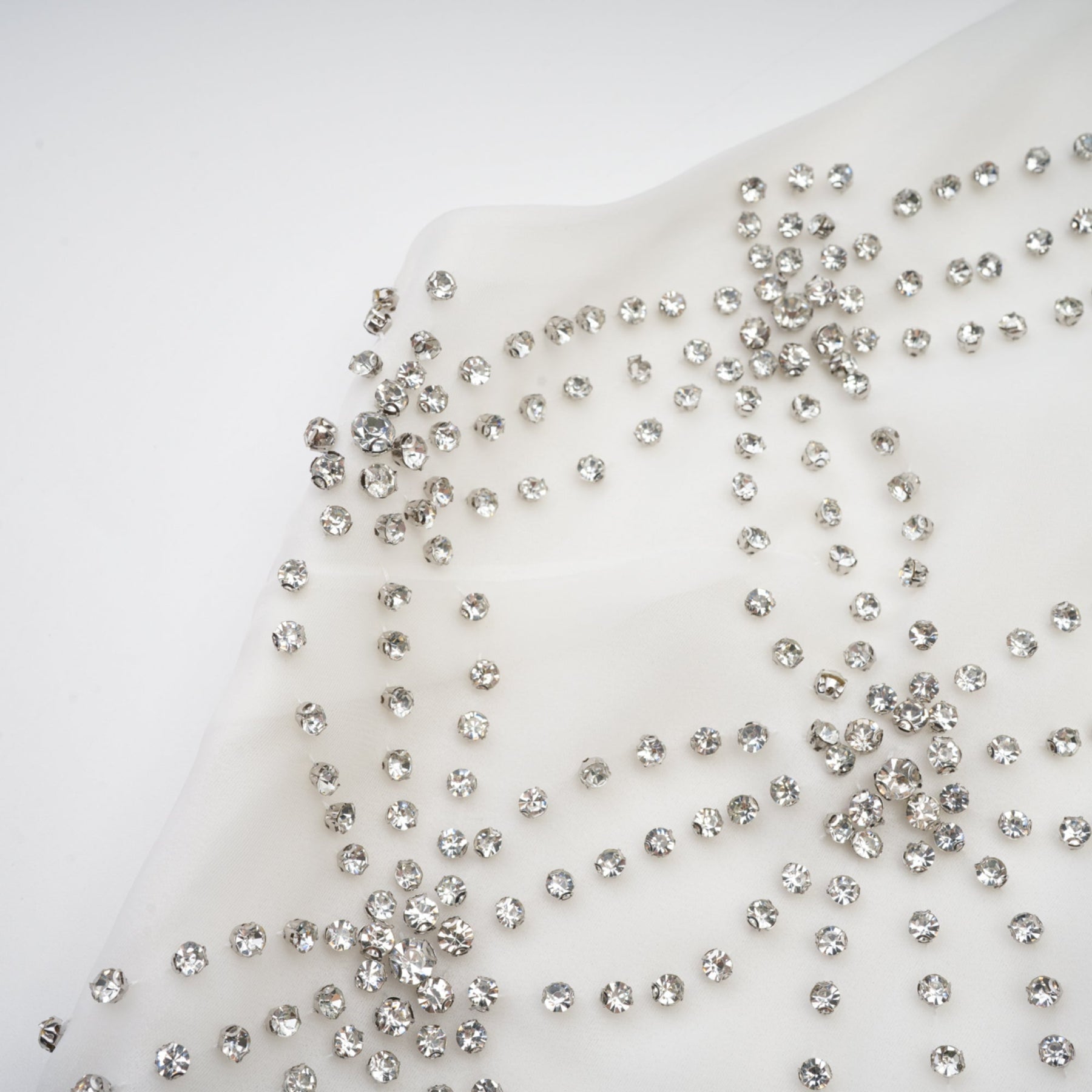 A woman wearing a long formal dress with embellishments and intricate detailing named Magdalena