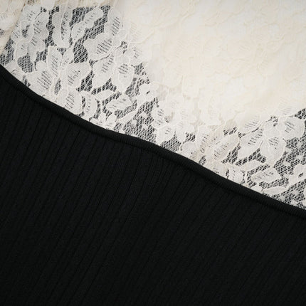 A woman wearing a long knit midi dress with lace trim details at the neckline and hem standing in a neutral pose against a plain background