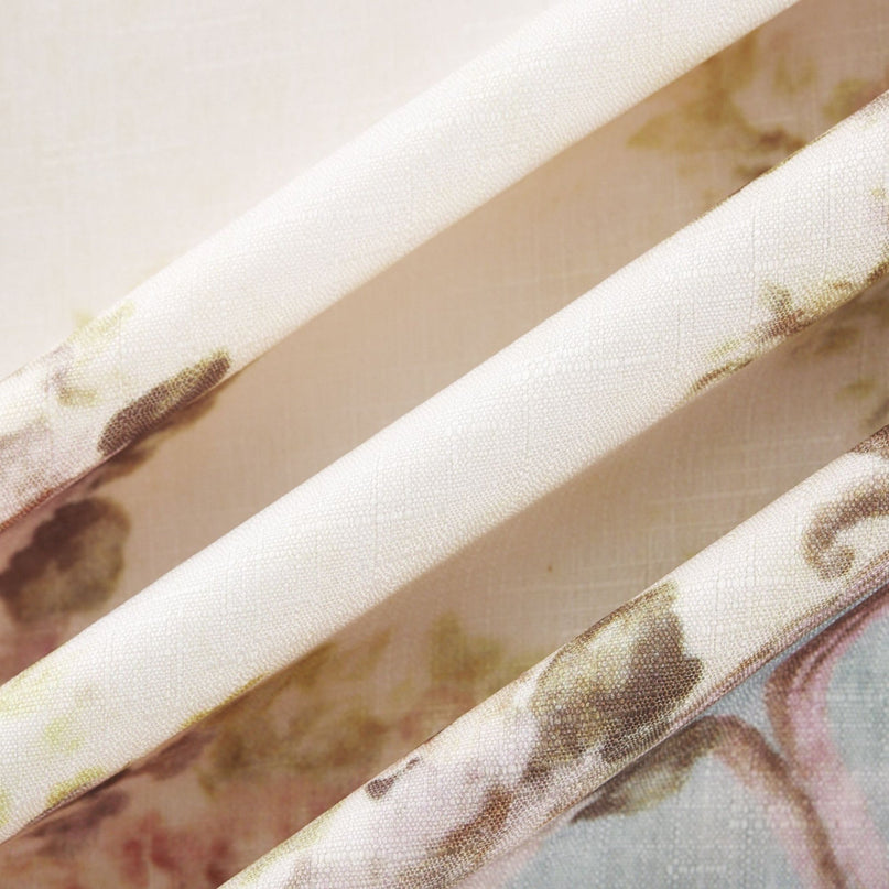 A woman wearing a long sleeve boho style dress with a floral print pattern The dress features a flowing skirt and bohemian inspired design in soft colors