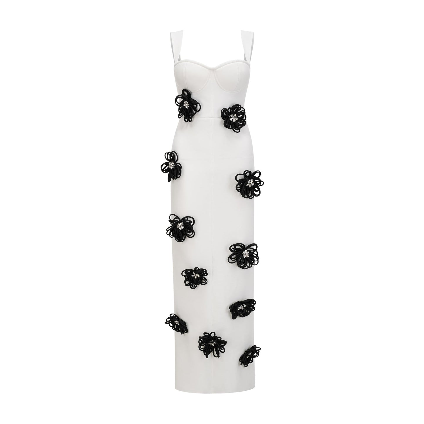 A woman wearing a long white bandage dress with floral applique detailing standing against a plain background