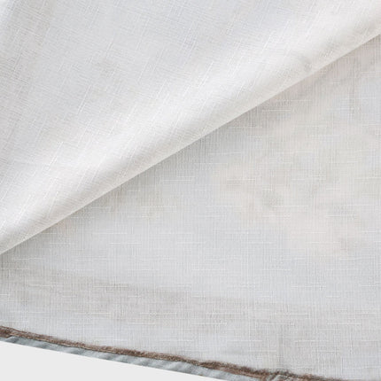 A woman wearing a longsleeve floral print boho dress with a flowing skirt and cinched waist standing in a field