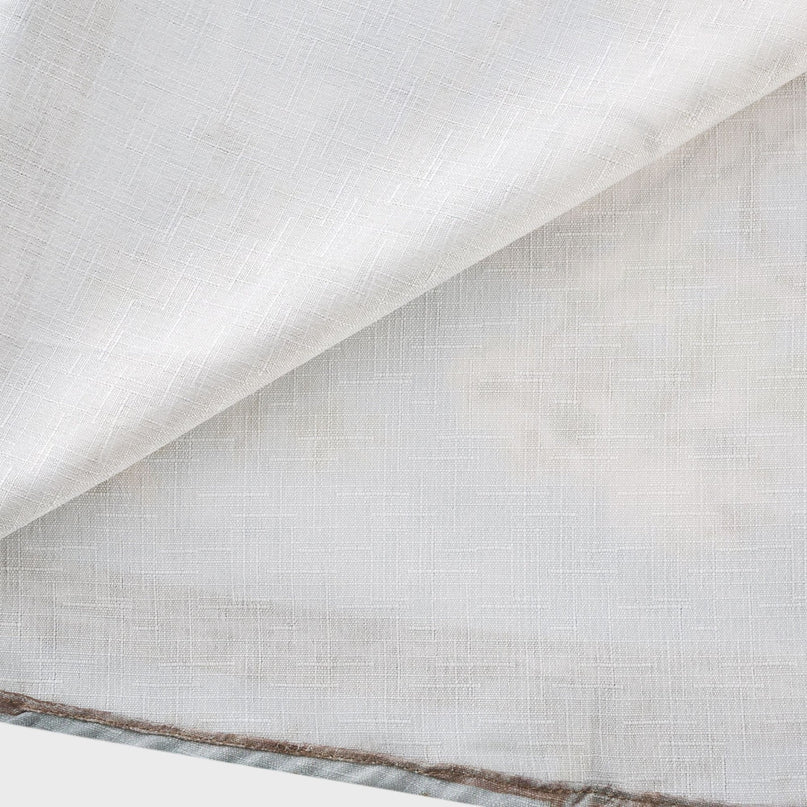 A woman wearing a longsleeve floral print boho dress with a flowing skirt and cinched waist standing in a field