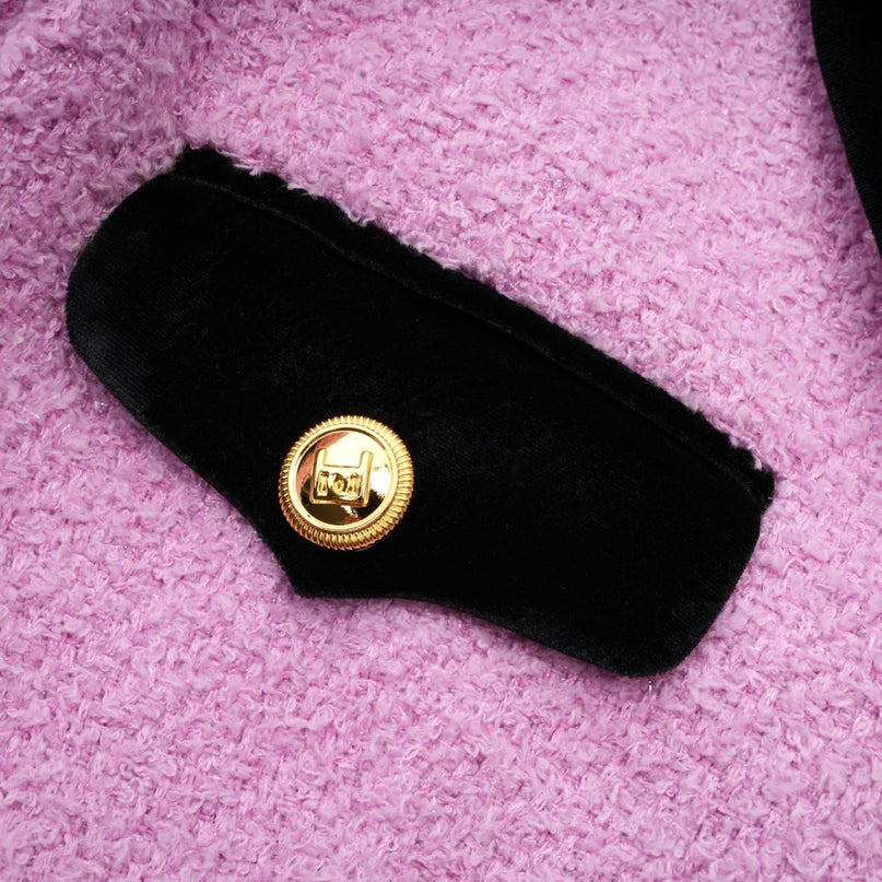 A woman wearing a matching blazer and skirt set in a professional style The blazer has a tailored fit and the skirt falls to knee length Both pieces are in a solid color likely in a business appropriate shade