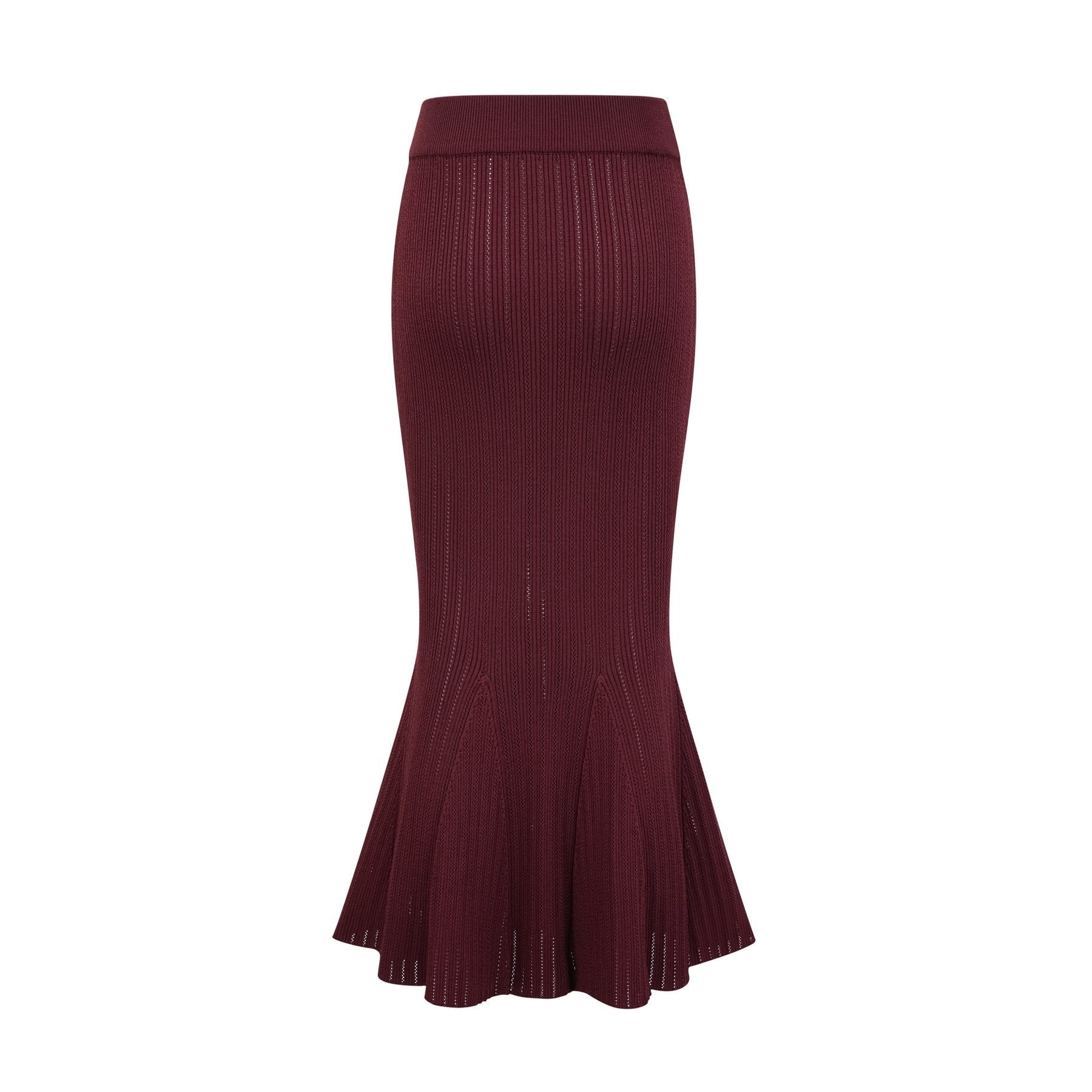 A woman wearing a matching red knit outfit consisting of a ruffled top and skirt The top has short sleeves and the skirt falls to mid thigh length The set is called Corrine and has a vibrant red color