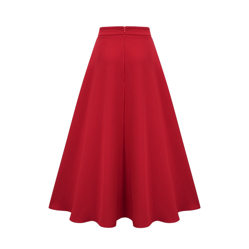 A woman wearing a matching red outfit consisting of a pleated blouse and skirt The blouse has long sleeves and the skirt falls to mid calf length The fabric appears lightweight and flowy
