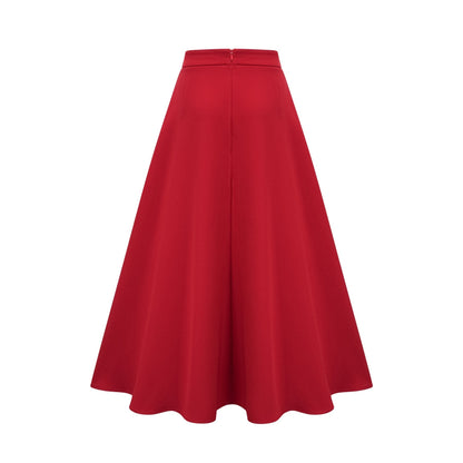 A woman wearing a matching red outfit consisting of a pleated blouse and skirt The blouse has long sleeves and the skirt falls to mid calf length The fabric appears lightweight and flowy