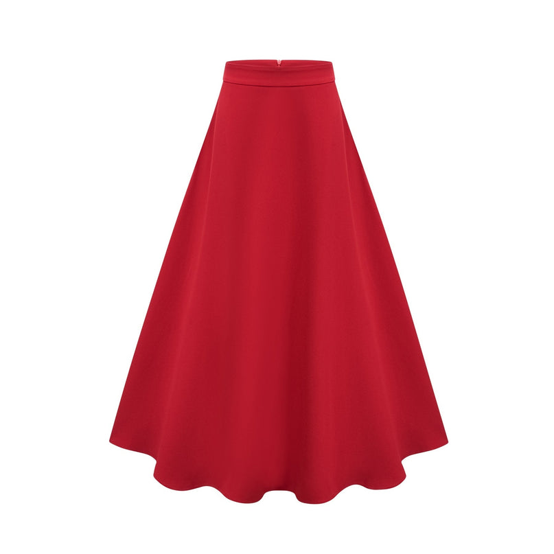 A woman wearing a matching red outfit consisting of a pleated blouse with a high collar and a pleated skirt the ensemble has a vintage inspired look