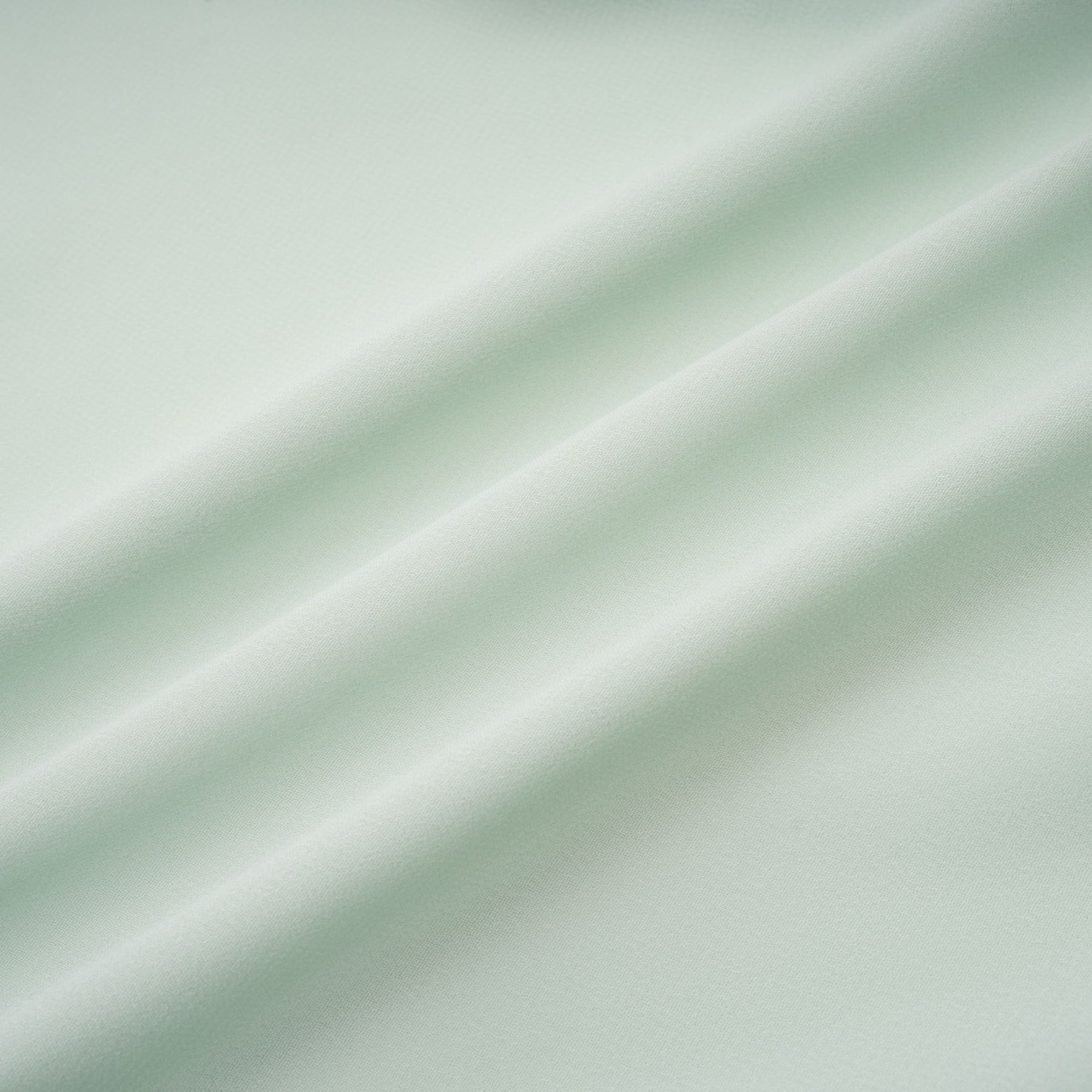 A woman wearing a midi length dress with ruffled details and embellishments The dress has a fitted silhouette and appears to be in a soft fabric