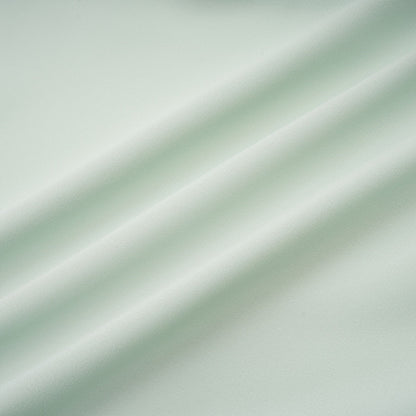A woman wearing a midi length dress with ruffled details and embellishments The dress has a fitted silhouette and appears to be in a soft fabric