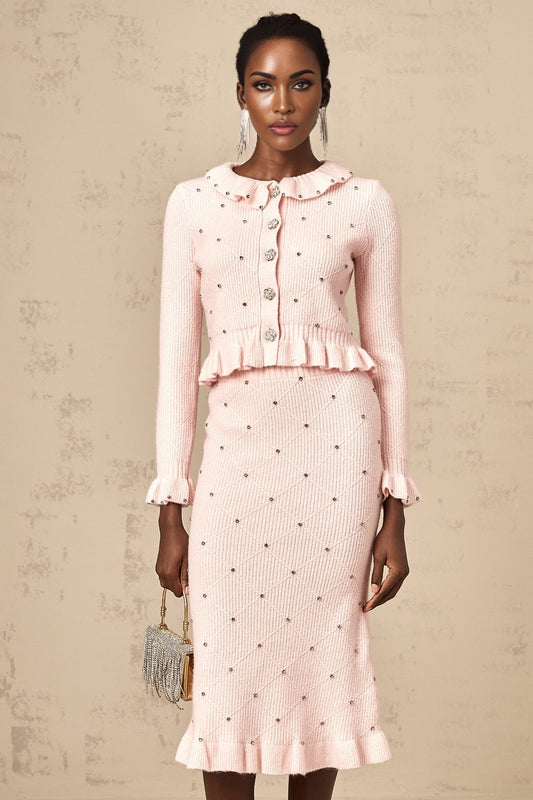 A woman wearing a pink knitted cardigan and matching skirt with an argyle check pattern The set is called Julia and features a coordinated top and bottom in a classic style